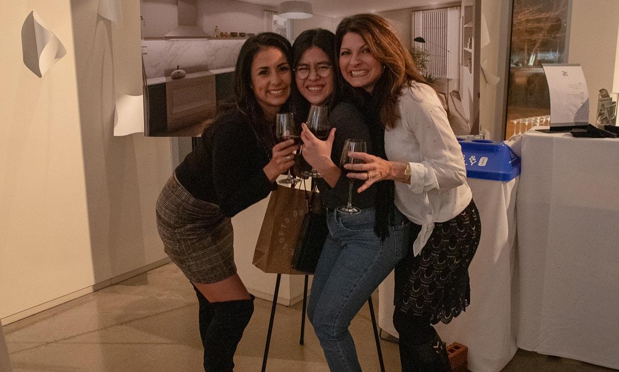 three women holding wine glasses