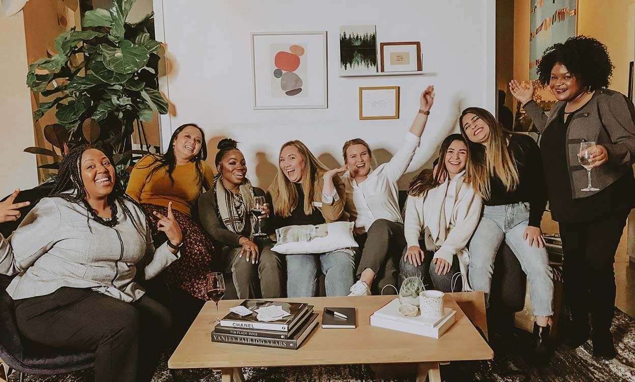 group of girl friends smiling and laughing in Brick Ave Lofts