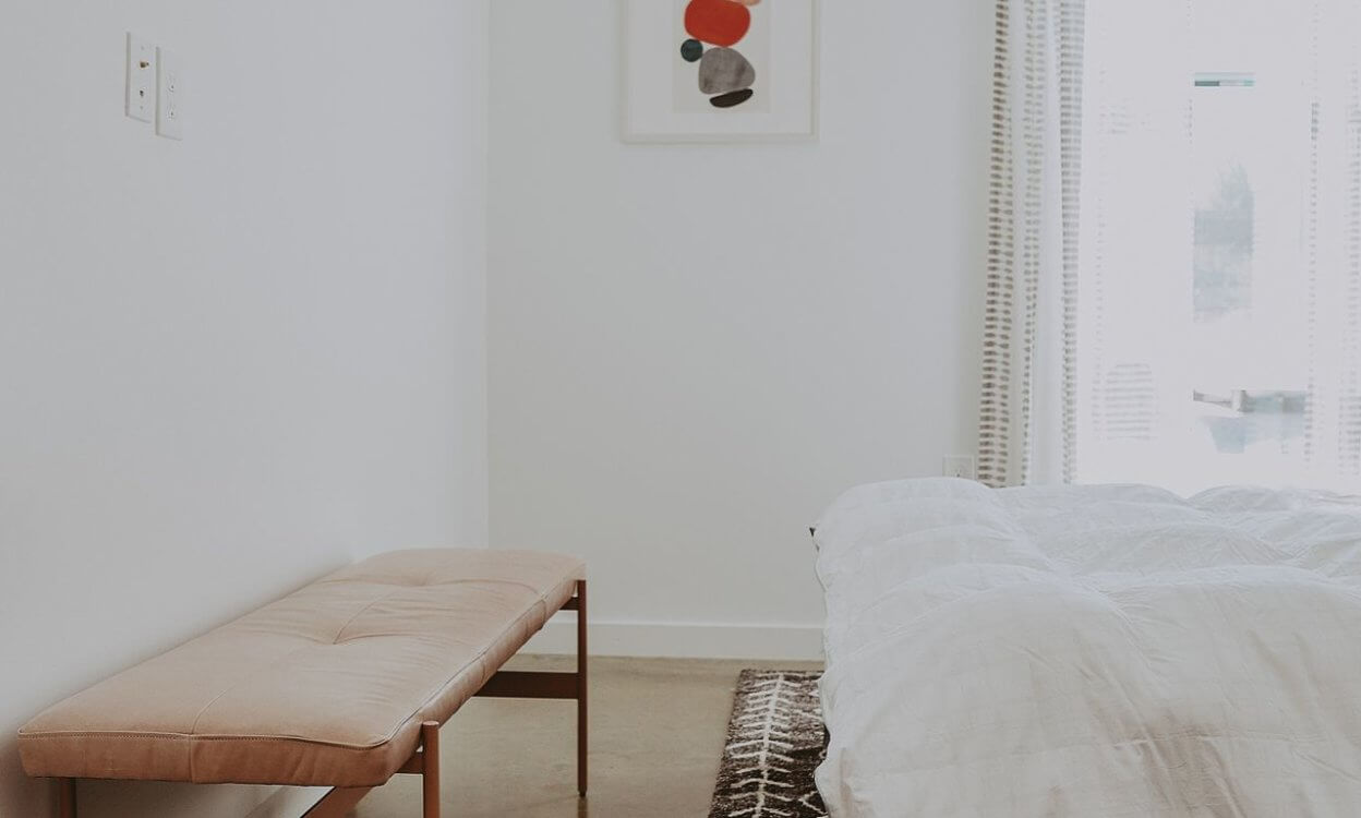Table at the end of the bed in apartment