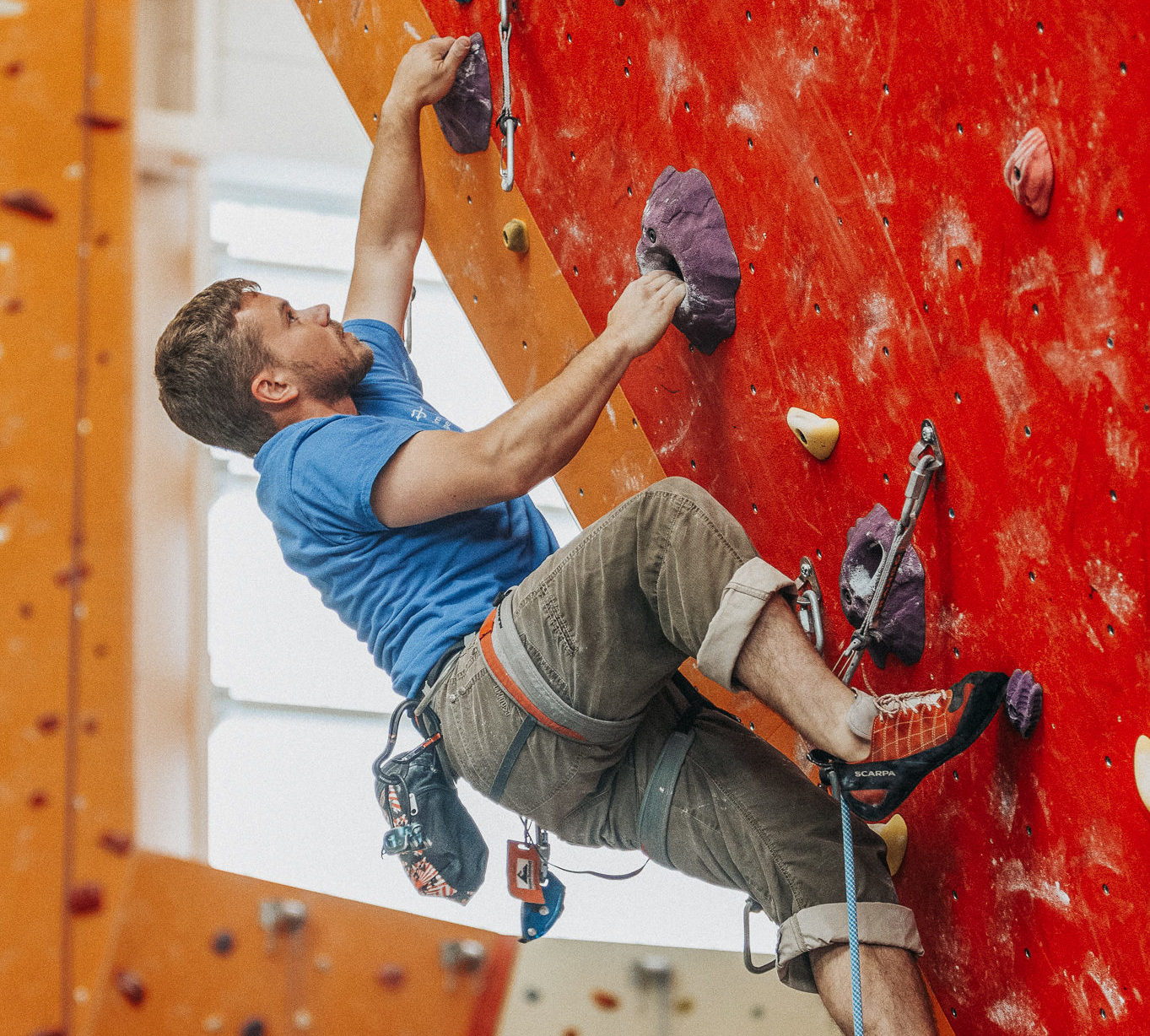 man rock wall climbing